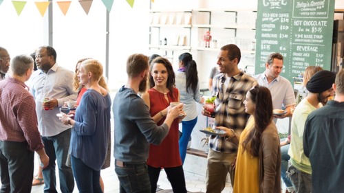 Group of people talking casually at a social gathering, representing advanced American accent topics like linking, reductions, and casual vs. formal speech in the American Accent Course Part 4