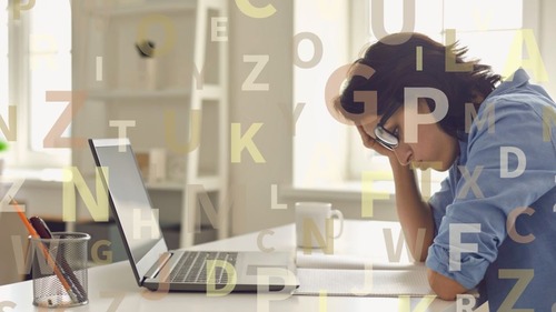 Woman studying on a laptop with letters in the background, representing learning difficult consonant sounds and idiomatic expressions in the American Accent Course Part 2